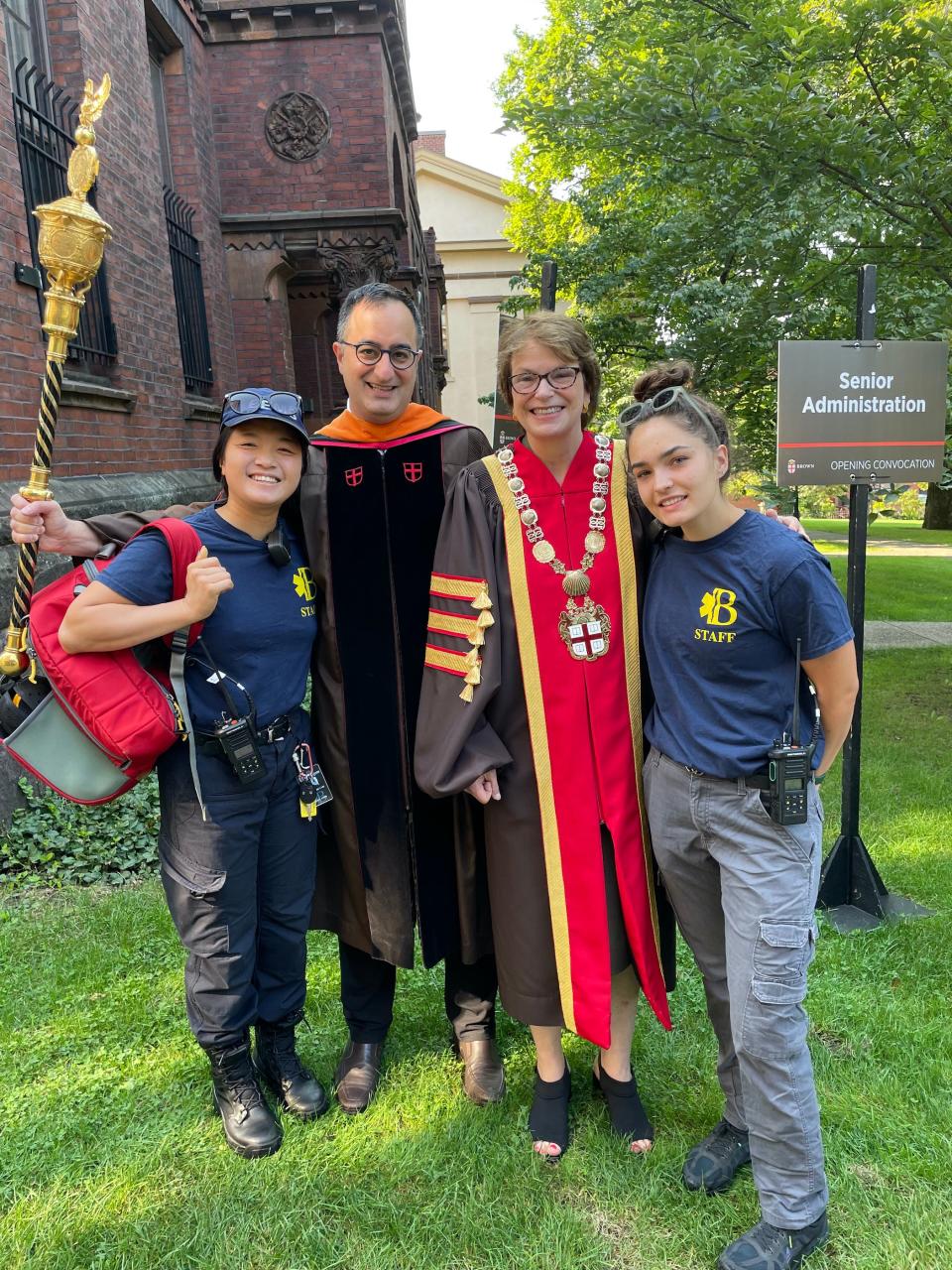 Rachel Huynh, left, attends Brown University on an Army ROTC scholarship. She works multiple part-time jobs, including as an emergency medical technician, to cover living expenses. Here she is pictured at Convocation with Rashid Zia, Dean of the College at Brown; Brown's president, Christina Paxson; and a fellow member of Brown EMS.