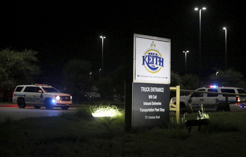 Authorities investigate the scene after a deadly shooting at Ben E. Keith distribution center Monday, Aug. 20, 2018, in Missouri City, Texas. Missouri City Police Chief Mike Berezin says the shooting happened during the overnight shift, when fewer workers are on duty. (Yi-Chin Lee/Houston Chronicle via AP)