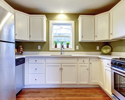 Conceal modern appliances behind cabinetry or build them into the kitchen side of an island (note the treatment of dishwasher, microwave and wine fridge).