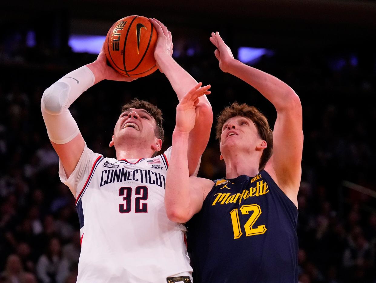 Connecticut's Donovan Clingan shoots over Marquette's Ben Gold during the first half on Saturday night.