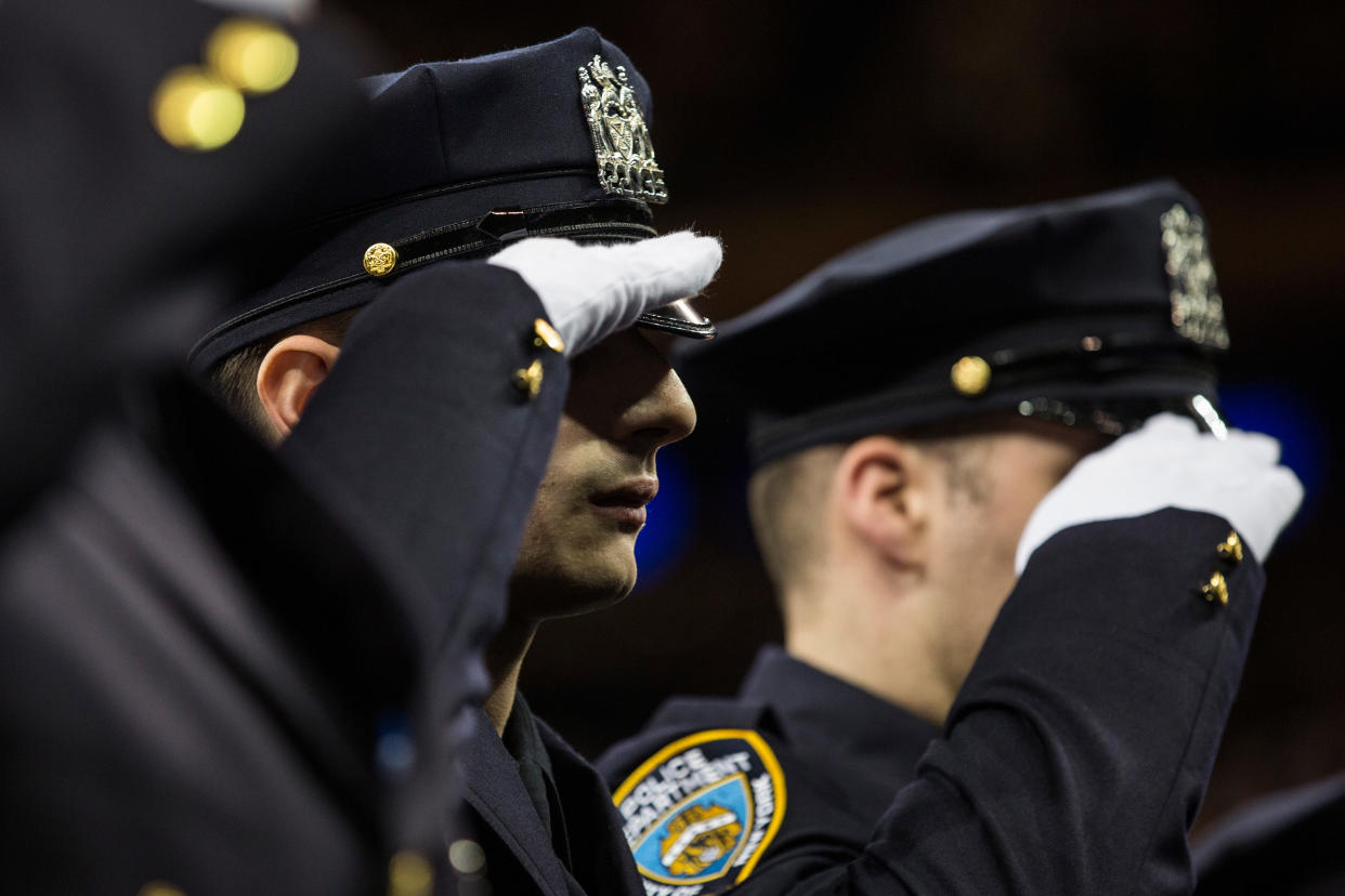 New York Police Department recruits salute during the NYPD&nbsp;graduation ceremony at Madison Square Garden in New York City&nbsp;on December 29, 2015. (Photo: Andrew Burton via Getty Images)