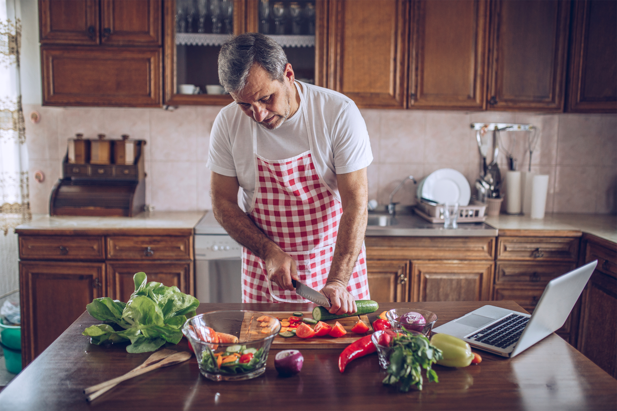 Older man preparing food in a home