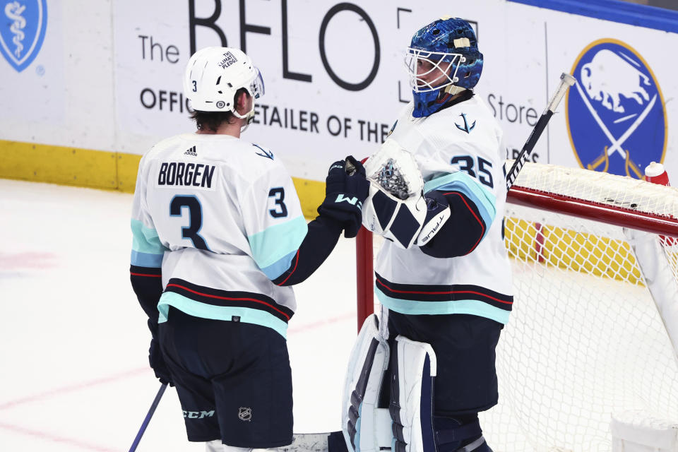 Seattle Kraken defenseman Will Borgen (3) and goaltender Joey Daccord (35) celebrate the team's win over the Buffalo Sabres in an NHL hockey game Tuesday, Jan. 9, 2024, in Buffalo, N.Y. (AP Photo/Jeffrey T. Barnes)