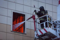 <p>Members of the Emergency Situations Ministry work to extinguish a fire in a shopping mall in the Siberian city of Kemerovo, March 25, 2018. (Photo: Maksim Lisov/Reuters) </p>