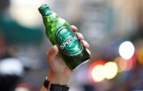 A drinker holds a bottle of Saigon beer (sabeco) at a restaurant in the Old Quarter in Hanoi