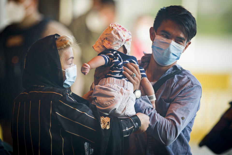 Evacuees from Afghanistan arrive after disembarking from a U.S. airforce plane at the Naval Station in Rota, southern Spain, Tuesday Aug. 31, 2021. The United States completed its withdrawal from Afghanistan late Monday, ending America's longest war. (AP Photo/ Marcos Moreno)