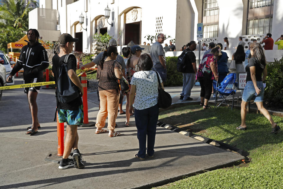 People line up outside a voting location at City Hall, Tuesday, Nov. 8, 2022, in Honolulu. (AP Photo/Marco Garcia)