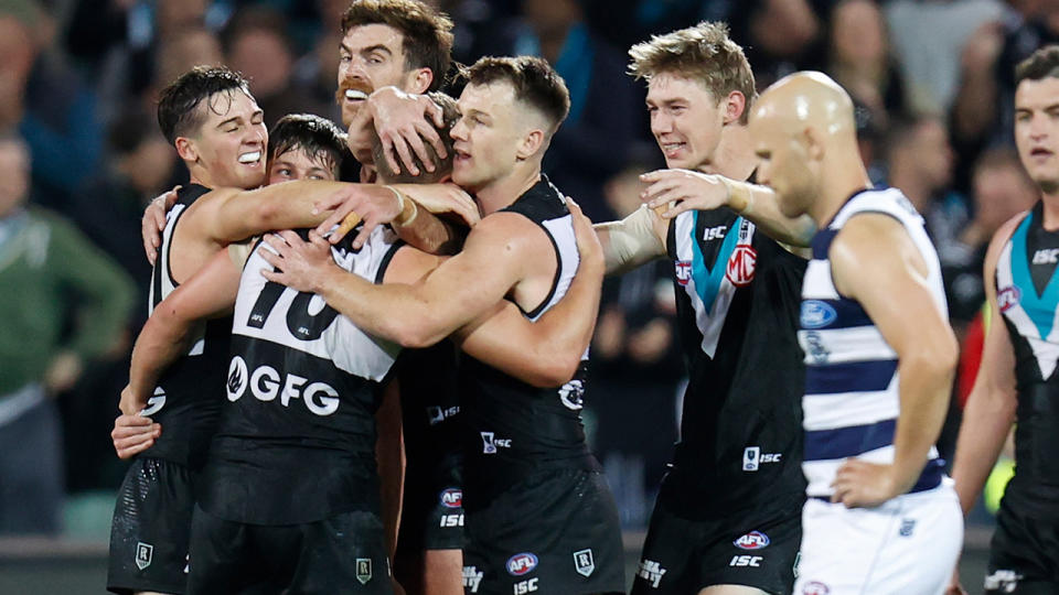 Port Adelaide players, pictured here celebrating a goal as Gary Ablett looks on.