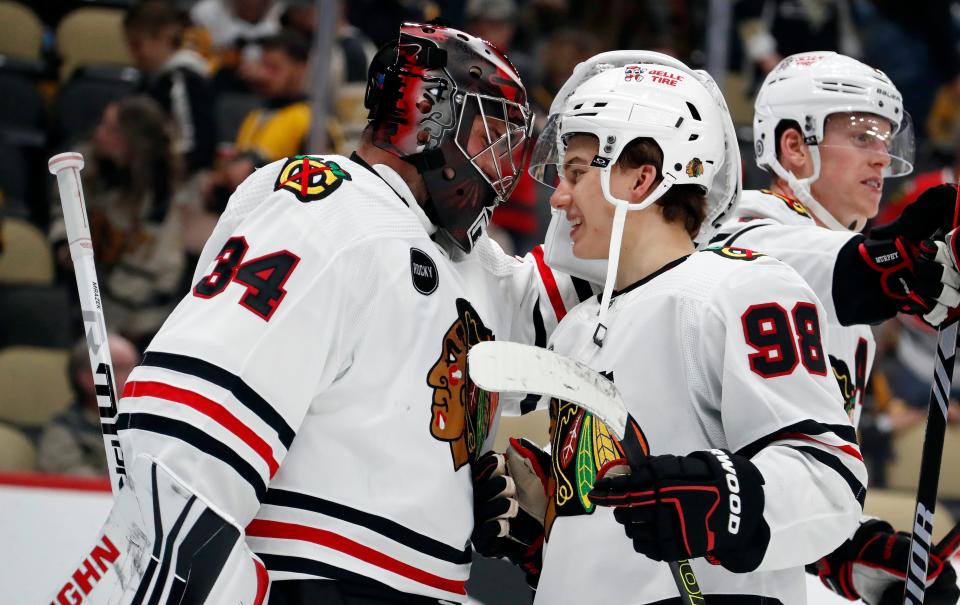 Chicago Blackhawks goaltender Petr Mrazek (34) and center Connor Bedard (98) celebrate after defeating the Pittsburgh Penguins.