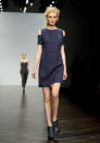 <b>London Fashion Week AW13: Zoe Jordan</b><br><br>A Zoe Jordan model hits the catwalk in a silk navy, crocodile-print shift with cut-out shoulder detailing.<br><br>©Rex