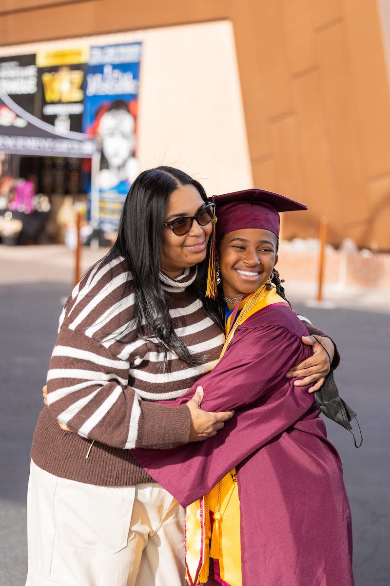 15-year-old Alena McQuarter receives a hug from her mother Daphne McQuarter following the ASU Barrett Honors College convocation on Monday, December 11, 2023.