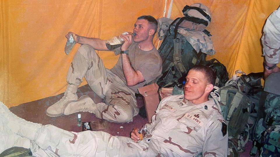 Capt. Bill Kirby, left, and 1st Sgt. Michael Grinston, right, eat field rations during rest at Camp New York, Kuwait, in February 2004 prior to movement into Iraq as part of Operation Iraqi Freedom II, February. (Photo courtesy of Brendan Dignan)