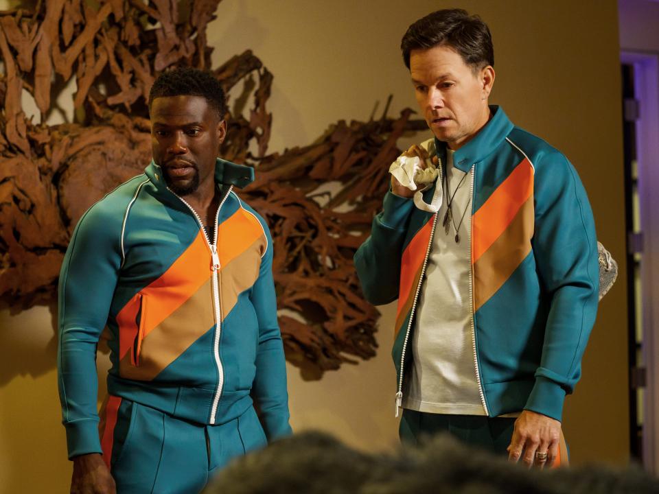 Kevin Hart and Mark Wahlberg in orange and blue tracksuits in "Me Time"