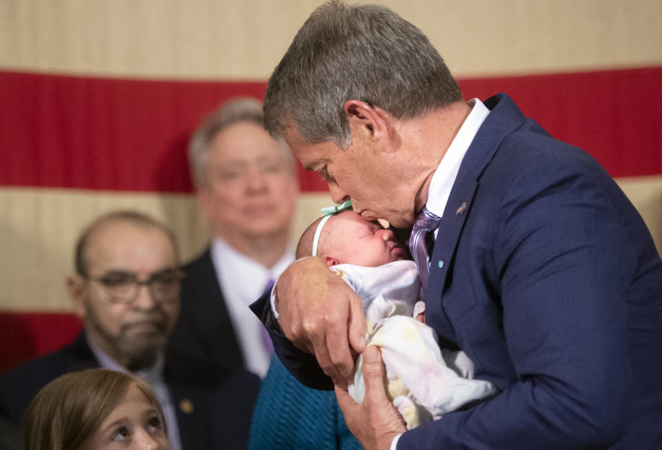 Nebraska Gov. Jim Pillen kisses newborn Gemma Pond at the signing ceremony of LB 574, Monday, May 22, 2023, in Lincoln, Neb. (Justin Wan/Lincoln Journal Star via AP)