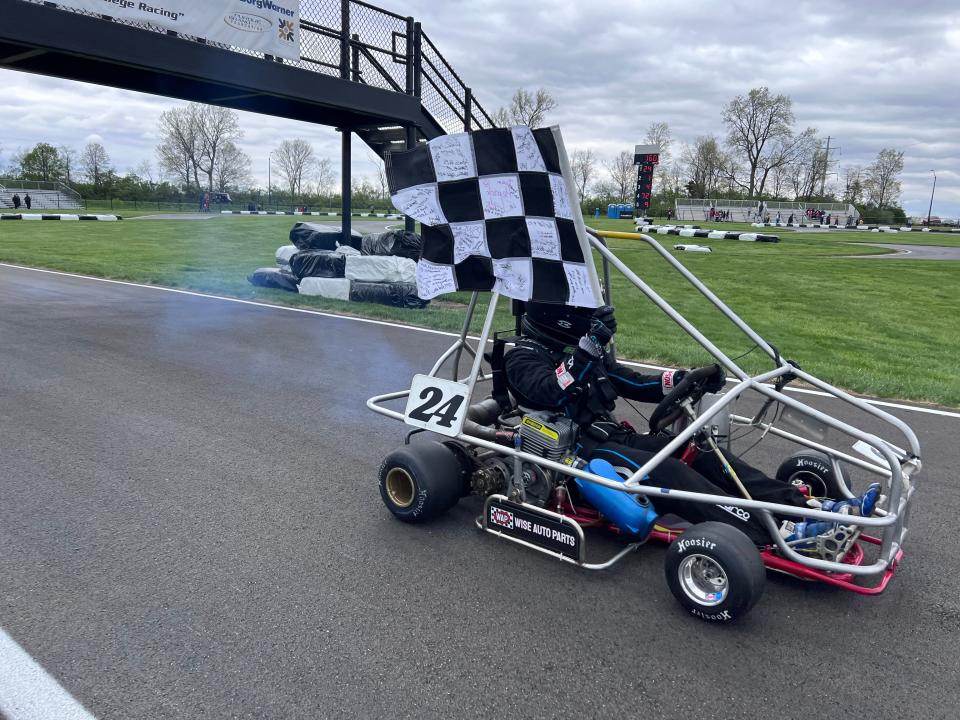 Senior Michael Cruz takes a victory lap with the checkered flag after winning the 66th Purdue Grand Prix on Saturday, April 22, 2023.