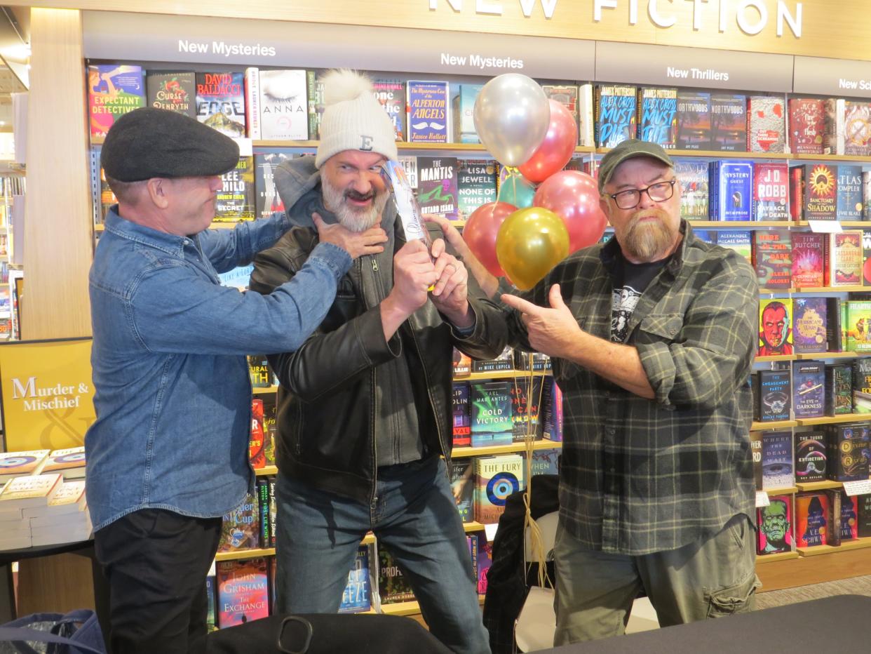 Mark Moran, left, and Mark Sceurman, right, of Weird NJ, joke with customer Earl Grosser at the grand reopening of the Barnes & Noble bookstore at the Shops at Ledgewood Commons in Roxbury.