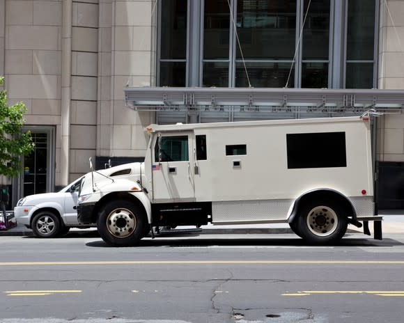 Armored truck parked on a city street.