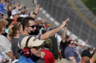 Fans hold up three fingers during a lap three tribute honoring the late Dale Earnhardt, Sr., during the NASCAR Daytona 500 auto race at Daytona International Speedway, Sunday, Feb. 14, 2021, in Daytona Beach, Fla. Dale Earnhardt, Sr., the all-time winner at Daytona, was killed in a fatal car crash at the speedway 20-years ago today. (AP Photo/Chris O'Meara)