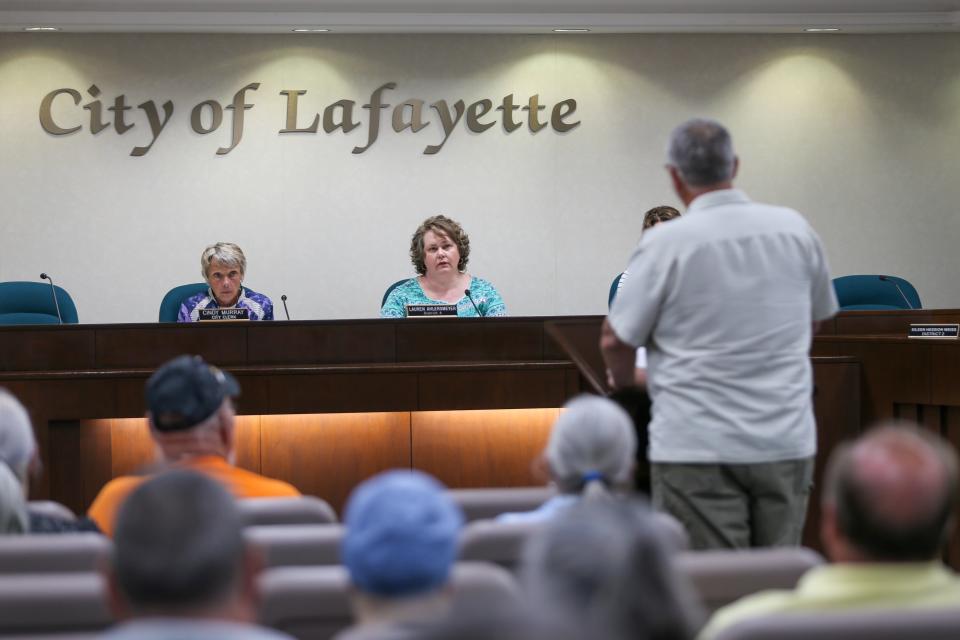 Cindy Murray, Lafayette City Clerk, and Lauren Ahlersmeyer, Lafayette city councilwoman, listen to Marc Buhrmester, Dayton town councilman, explain why the town of Dayton will continue to fight against the voluntary annexation of the Carr family property into the city of Lafayette, at June's Lafayette City Council meeting, on Monday, June 5, 2023, in Lafayette, Ind.