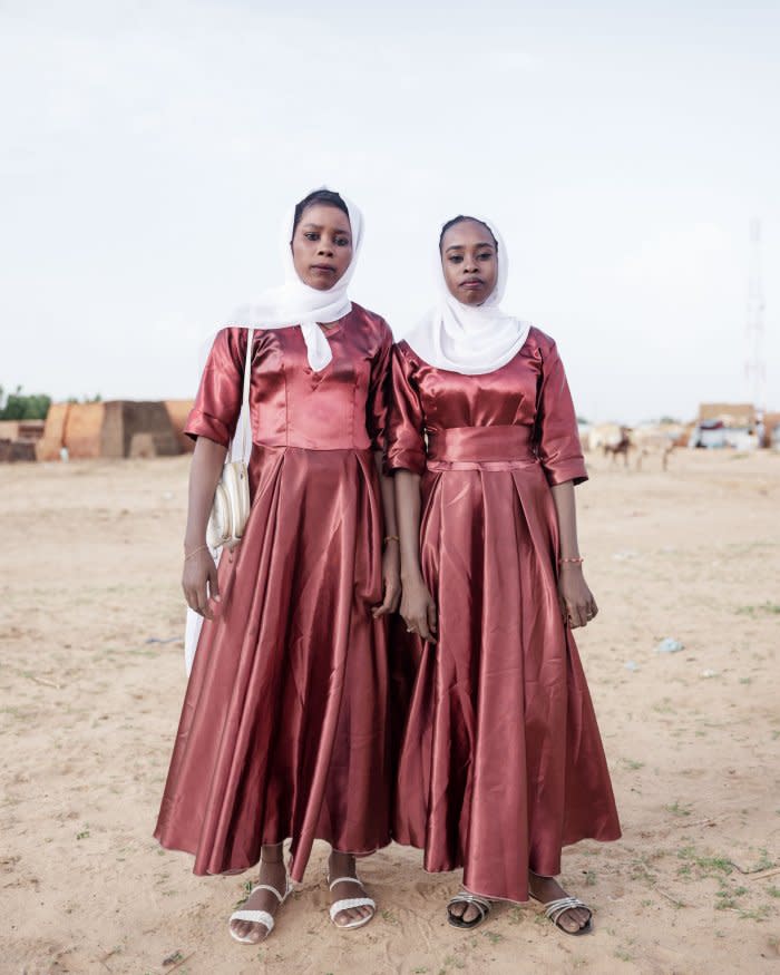 Namarkh Babikir (left) and Hawa Adam (right) stand together during a wedding at Adré refugee camp.<span class="copyright">Nicolò Filippo Rosso</span>