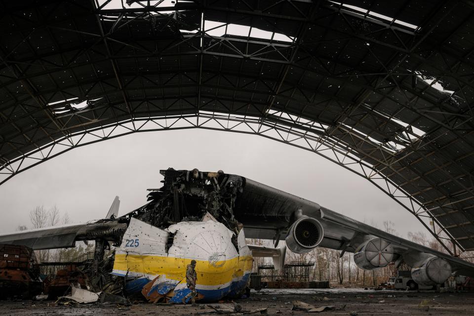 A Ukrainian serviceman walks past the Antonov An-225 aircraft.