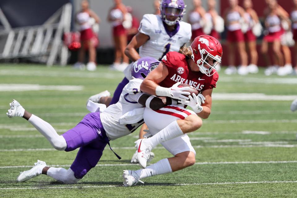 Sep 2, 2023; Little Rock, Arkansas, USA; Arkansas Razorbacks tight end Luke Hasz (9) catches a pass in the first quarter as Western Carolina Catamounts safety Andreas Keaton (21) makes a tackle at War Memorial Stadium. Mandatory Credit: Nelson Chenault-USA TODAY Sports
