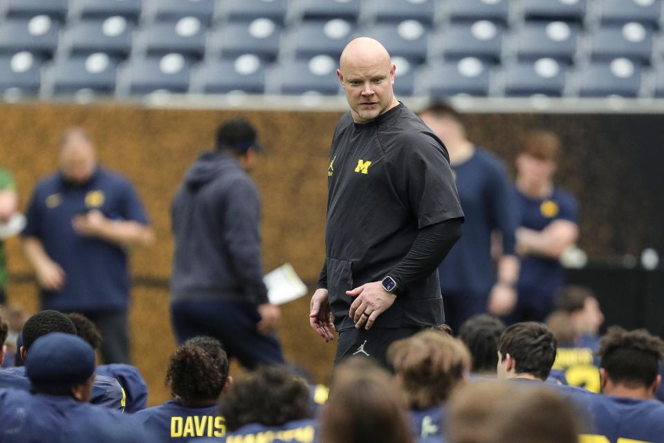 Michigan strength and conditioning coach Ben Herbert watches warmups during open practice at NRG Stadium in Houston, Texas on Saturday, Jan. 6, 2024.