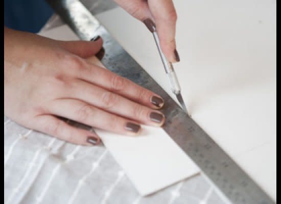 Cut along the lines using an x-acto knife. To make sure the cuts are straight, use a ruler to guide the knife. 