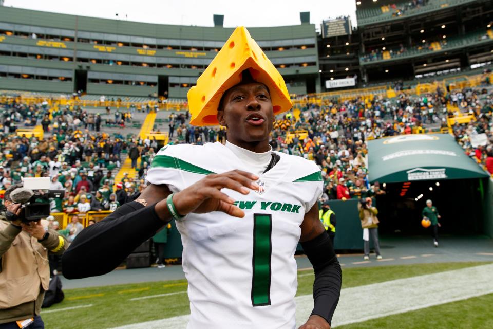 New York Jets cornerback Sauce Gardner celebrates defeating the Green Bay Packers in October by wearing a cheesehead on the field