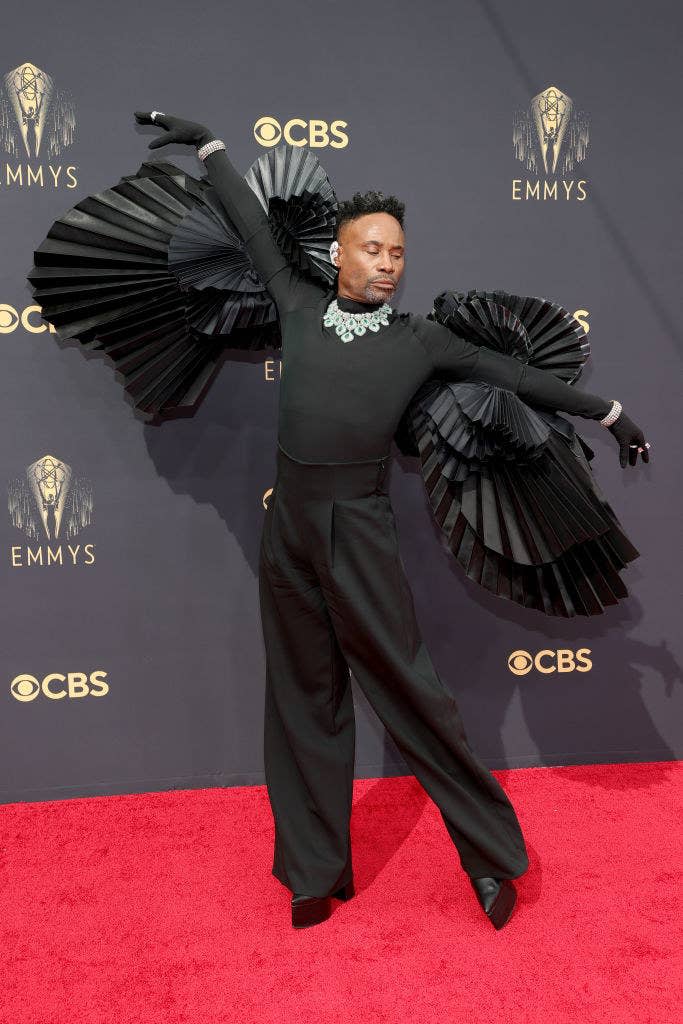 Billy Porter with his arms outstretched to show off the ruffled sleeves