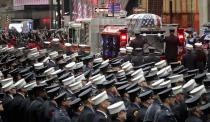 A fire truck leaves carrying the casket of U.S. Marine Corps Staff Sergeant and FDNY Firefighter Christopher Slutman, after his funeral service at St. Thomas Episcopal Church, Friday April 26, 2019, in New York. (AP Photo/Bebeto Matthews)