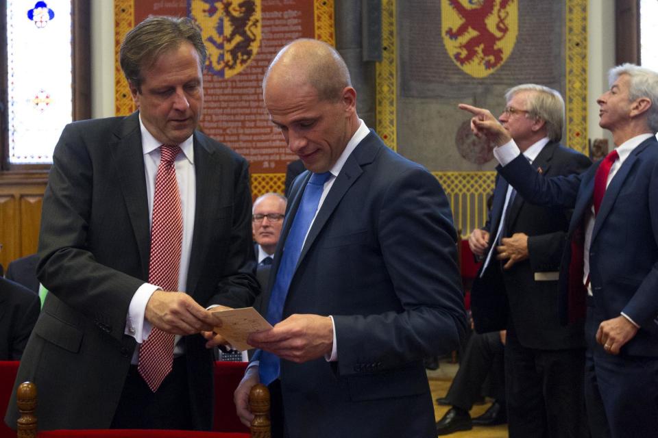 Diederik Samson of the Labour Party, centre, has a talk with Alexander Pechtold, left, of the Democratic party D66 prior to the opening of the new parliamentary year by Dutch Queen Beatrix with a speech outlining the government's plans for its 2013 budget in The Hague, Netherlands, Tuesday, Sept. 18, 2012. Queen Beatrix will address the nation amid the usual pomp and circumstance, but the in uncomfortable knowledge that her speech was written by a Cabinet that is about to be replaced after national elections last week. (AP Photo/Vincent Jannink, Pool)