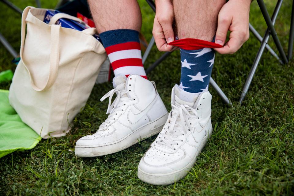 Aaron Davis pulls up his American themed socks during the Fourth of July concert and fireworks display at Pat and Lou Sisbarro Community Park on the New Mexico State University campus in Las Cruces on Monday, July 4, 2022.