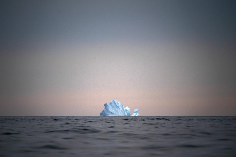 A large Iceberg floats away as the sun sets near Kulusuk, Greenland, on Aug. 15, 2019. (AP Photo/Felipe Dana)