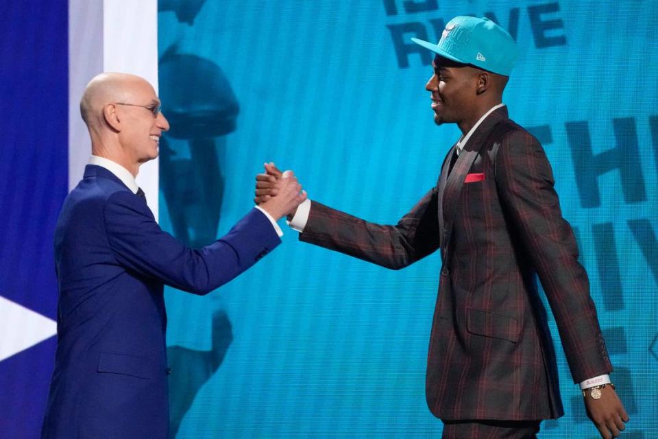 Brandon Miller, right, greets NBA Commissioner Adam Silver after being selected second overall by the Charlotte Hornets during the NBA Draft on Thursday night in New York.