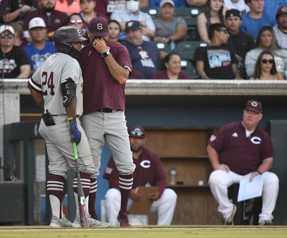 Sinton coach Adrian Alaniz talks to Jaquae Stewart during a Class 4A regional final game at Whataburger Field in Corpus Christi earlier this month. Alaniz just led the Pirates to the Class 4A state championship. He's in his seventh year and will draw interest from other schools, perhaps even colleges.