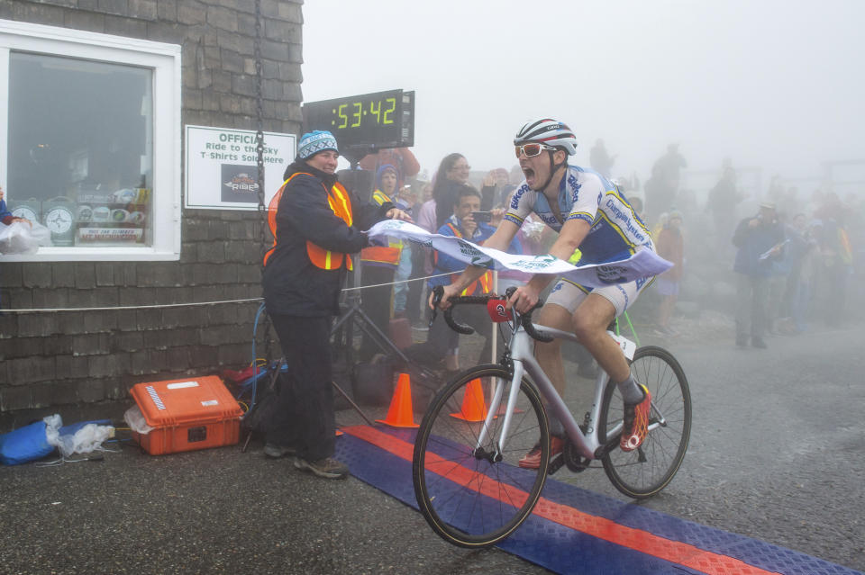 This photo provided by Joe Viger Photography, Erik Levinsohn breaks the tape and claims the overall win at Mt. Washington Bicycle Hillclimb in a time of 53:42 on Saturday, Aug. 17, 2019. Levinsohn, of Boston beat the competition in the men's divisions of the 7.6-mile (12-kilometer) Mount Washington Auto Road Bicycle Hillclimb to the summit at 6,288 feet (1,915 meters). (Joe Viger Photography via AP)