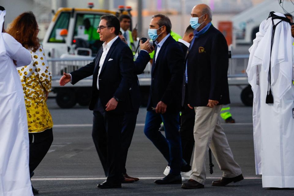 U.S. citizens Siamak Namazi, second from left, Emad Shargi, center, and Morad Tahbaz, right, are greeted upon their arrival at the Doha International Airport in Doha on Monday.