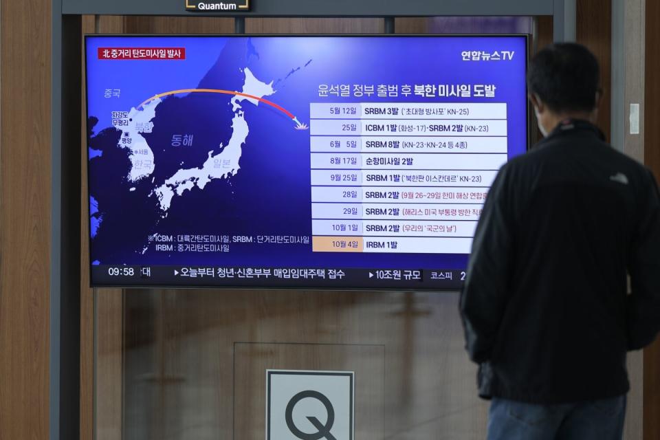 Man looking at TV screen in Seoul's railway station