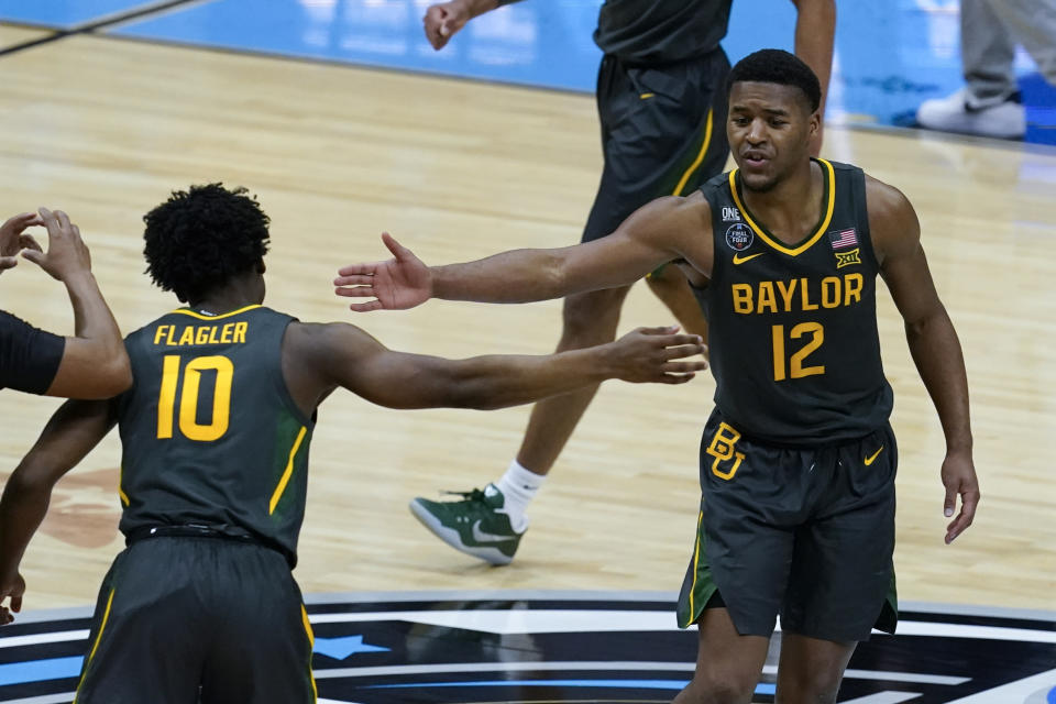 Baylor guard Jared Butler (12) celebrates with teammate guard Adam Flagler (10) during the second half of the championship game against Gonzaga in the men's Final Four NCAA college basketball tournament, Monday, April 5, 2021, at Lucas Oil Stadium in Indianapolis. (AP Photo/Darron Cummings)