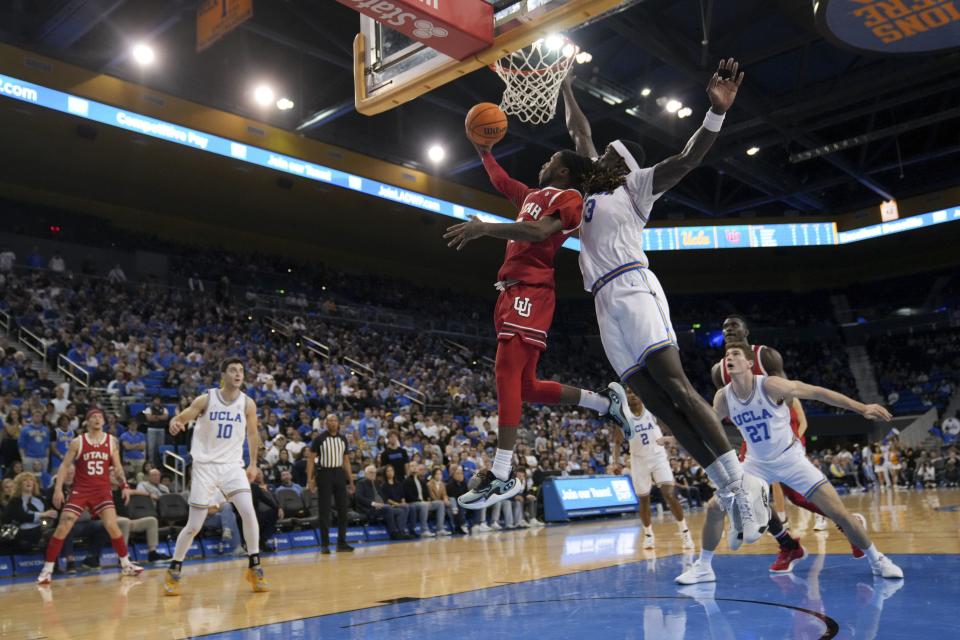 Utah guard Deivon Smith (5) drives to the basket against UCLA forward Adem Bona (3) during the first half of an NCAA college basketball game, Sunday, Feb. 18, 2024, in Los Angeles. | Eric Thayer, AP