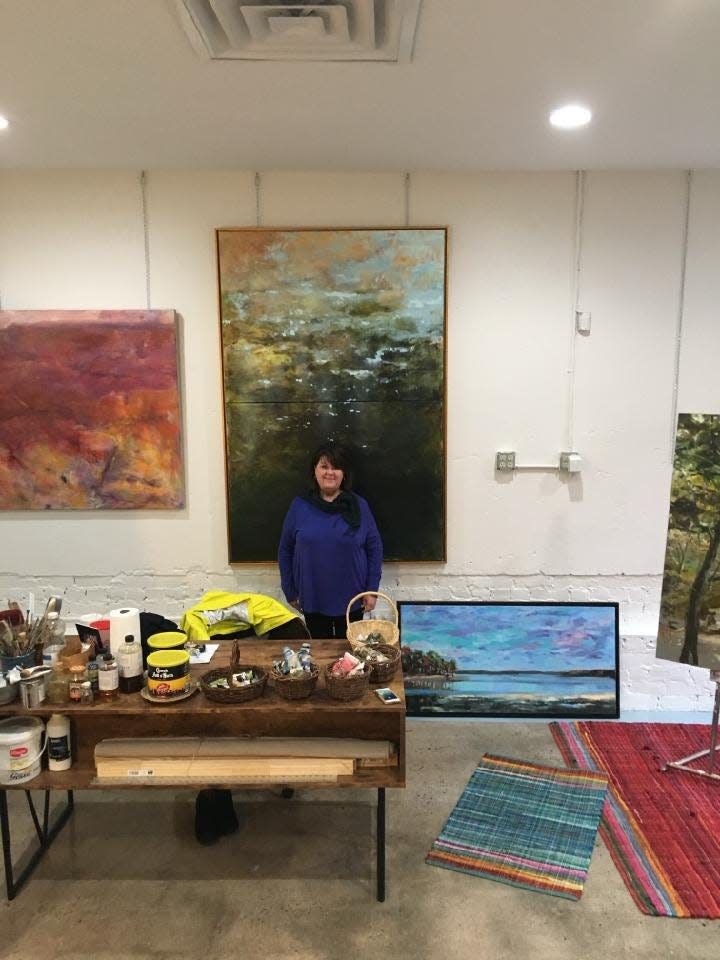 Chrys Riviere-Blalock shows some of her paintings. Riviere-Blalock is one of the recipients of an artist grant and has her work displayed at the Cleveland County Arts Council as part of a local artist exhibit.