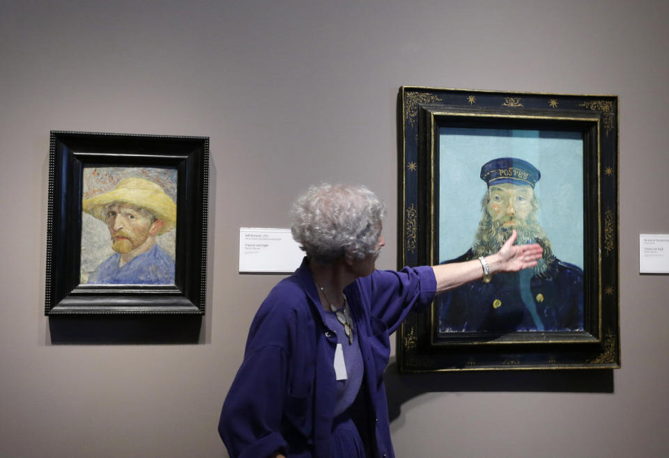 FILE - In a June 13, 2013 file photo, Detroit Institute of Arts docent Lea Schelke points out details in the Portrait of Postman Roulin by Van Gogh displayed at the museum in Detroit. As part of the city’s Chapter 9 bankruptcy filing, city emergency manager Kevyn Orr said Monday, Aug. 5, 2013, that he has asked the Christie’s auction house to appraise the museum’s collection, raising the possibility it could be put up for sale. (AP Photo/Carlos Osorio, File)