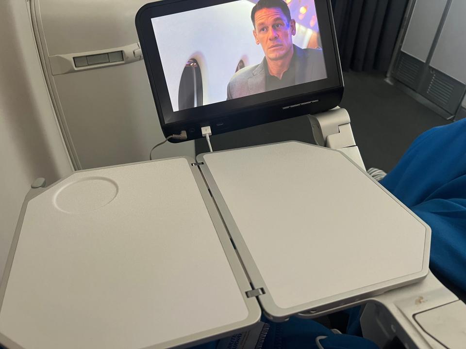 The television and tray table with John Cena on the screen.