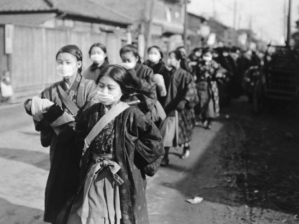 Japanese schoolgirls wearing protective masks.