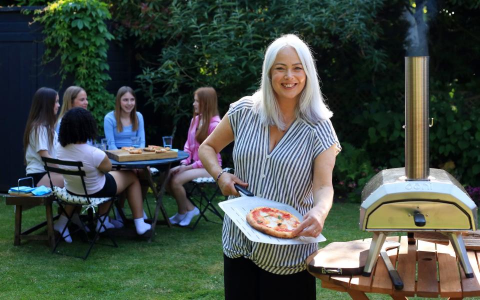 Food writer Silvana Franco is seen using an Ooni outdoor pizza oven to make pizza for her daughter and her friends - Clara Molden for The Daily Telegraph