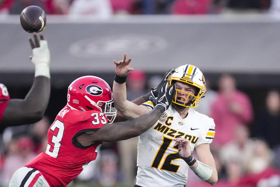 Missouri quarterback Brady Cook (12) is hit by Georgia linebacker C.J. Allen (33) as he releases a pass during the second half of an NCAA college football game, Saturday, Nov. 4, 2023, in Athens, Ga. (AP Photo/John Bazemore)