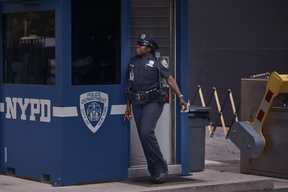 A police officer stands guard outside One Police Plaza NYPD Headquarters on Friday, Sept. 13, 2024, in New York. (AP Photo/Andres Kudacki)