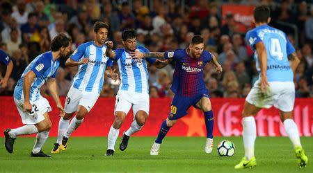 Soccer Football - La Liga Santander - FC Barcelona vs Malaga CF - Camp Nou, Barcelona, Spain - October 21, 2017 Barcelona’s Lionel Messi in action Malaga's Gonzalo Castro REUTERS/Albert Gea
