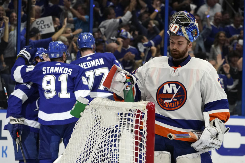 New York Islanders goaltender Ilya Sorokin, right, reacts after Tampa Bay Lightning players celebrate another goal during the second period in Game 5 of an NHL hockey Stanley Cup semifinal playoff series Monday, June 21, 2021, in Tampa, Fla. (AP Photo/Chris O'Meara)